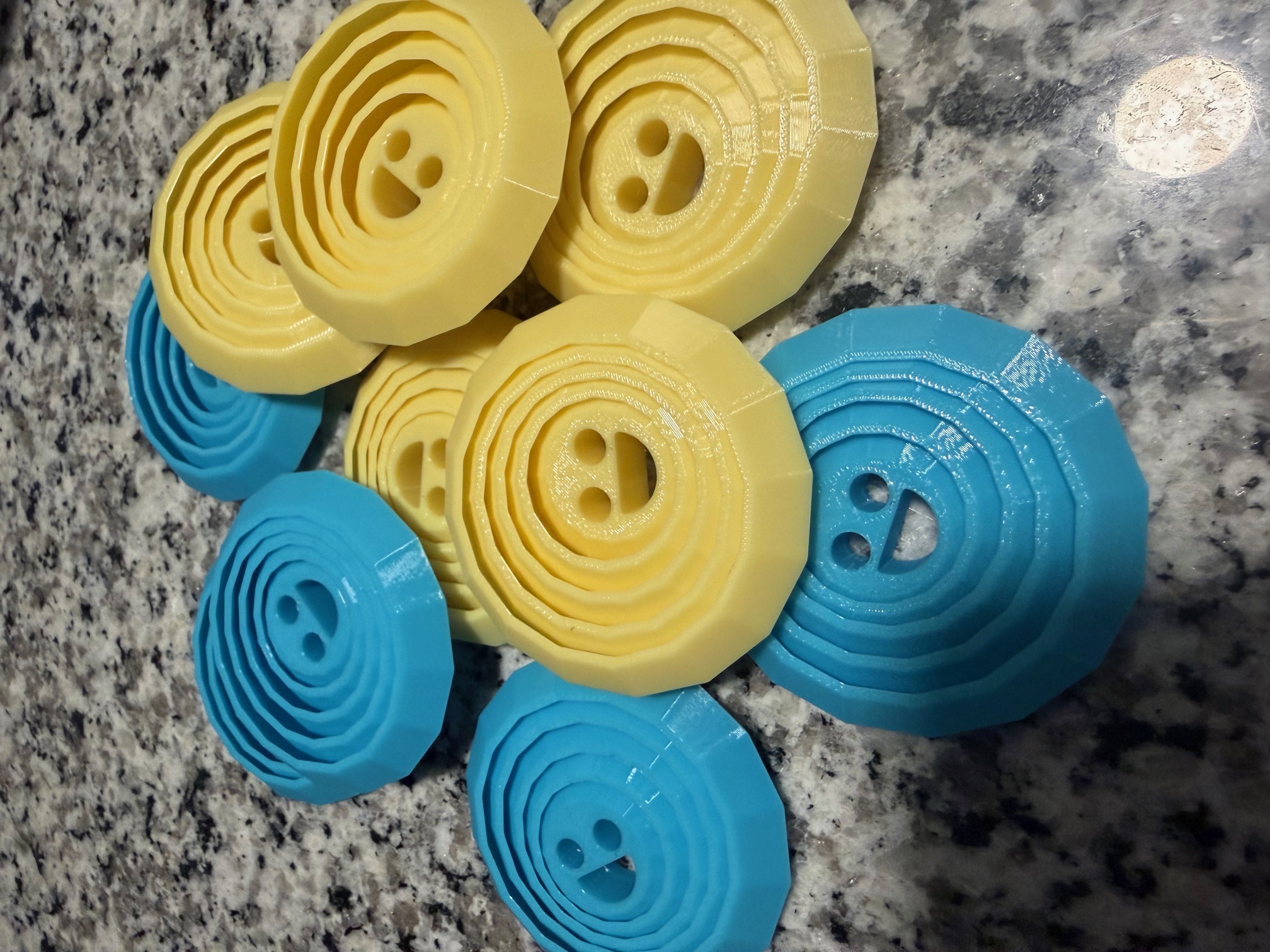 Blue and yellow smiley face fidget toys printed as party favors