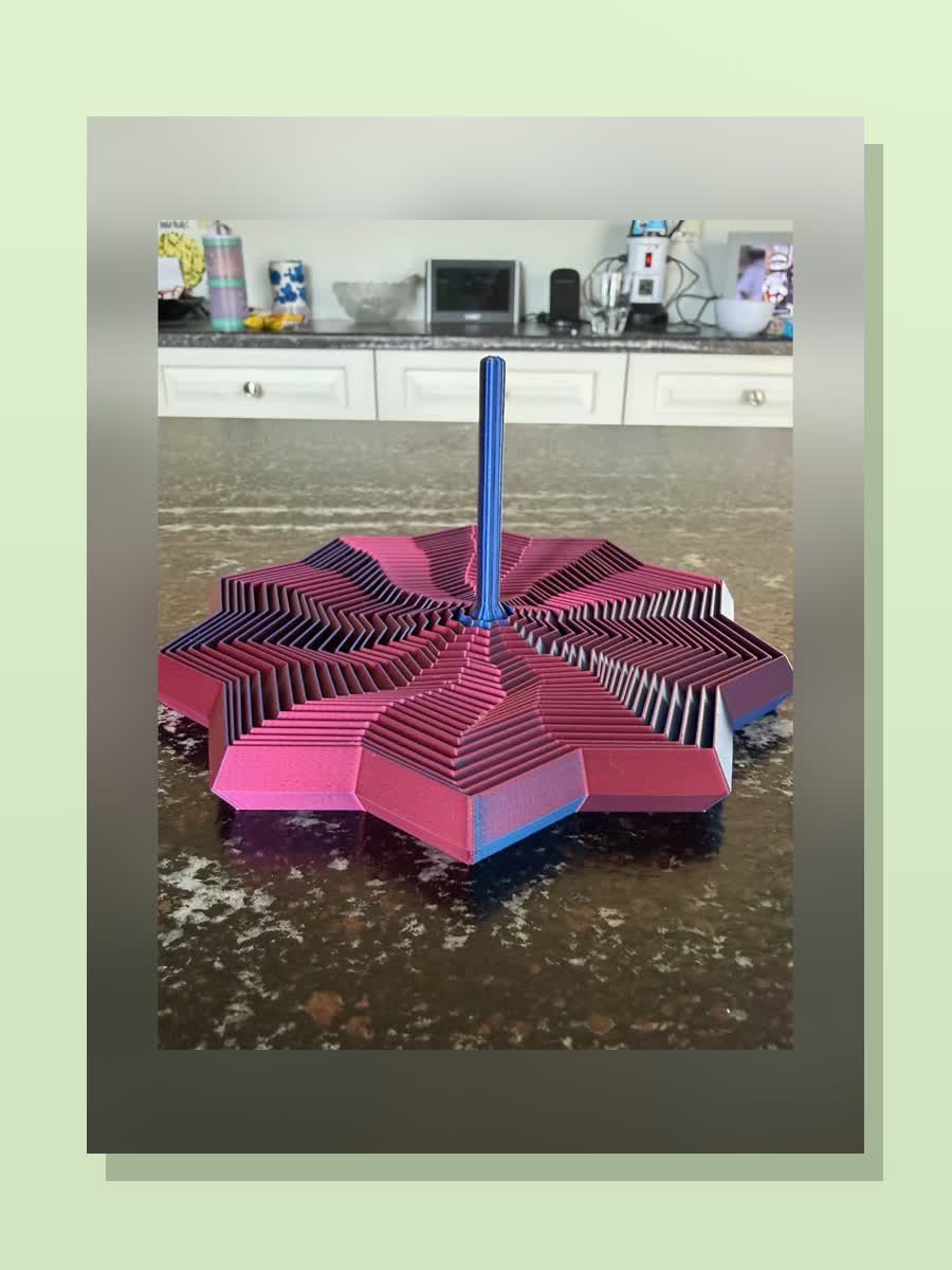 Dual-color 3D printed star fidget with a pink and blue finish